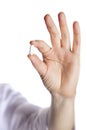 Pill in a hand on a white background close-up Royalty Free Stock Photo