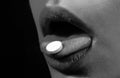 Pill and the mouth, isolated on black background. Close up woman with pills supplement. Vitamins, natural beauty
