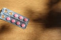 Pill plate on a wooden lacquered surface Royalty Free Stock Photo