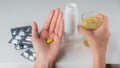 Pill tablet and a glass of water and lemon in your hands against the background of cold medicines Royalty Free Stock Photo