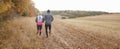 Pillar Box Format Shot Of Mature Couple Running Around Field Royalty Free Stock Photo