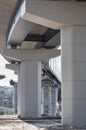 Pillar of bridge. Underside of an elevated roads. Gray pillars support the weight of the structure. Vital part of