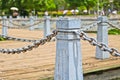 Pillar and chain fence down on a lake side