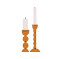 Pillar cylinder candles in candlesticks, holders. Unlit wax poles, tall pillars in candleholders. Cozy home decoration