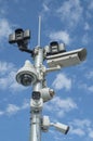 Pillar with different security cameras and motion sensors in blue sky Royalty Free Stock Photo