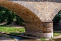 Large stone bridge with a small river Royalty Free Stock Photo