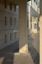 Pillar on the porch of the building with windows of different sizes