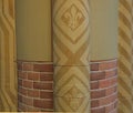 Pillar of red bricks and plaster with fleur de lis Royalty Free Stock Photo