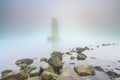 Pillar of a storm surge barrier in fog during sunset Royalty Free Stock Photo