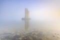 Pillar of a storm surge barrier in fog during sunset Royalty Free Stock Photo