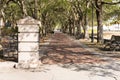 Pillar and tree-lined, shaded brick walkway in Charleston Riverfront Park