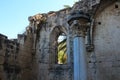 The pillared room of Bellapais Abbey, where meetings were once held, with a column and a barred window. White Abbey, the Abbey of