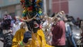 Portrait of man dressed as a black and yellow devil parading in the Diablada Pillarena in the city of Pillaro - Ecuador