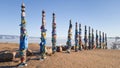 Pillars with colored ribbons on them in the place of power on lake Baikal - Cape Burhan near the village of Khuzhir. Lake Baikal