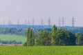 Pillars of High voltage electric lines in a field Royalty Free Stock Photo