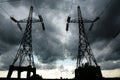 Pillars of line power electricity on gray storm clouds