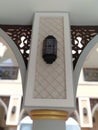 the pillars of the mosque are decorated with antique-looking lamps