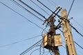 Pillars with old rusty box and crossing cables Royalty Free Stock Photo