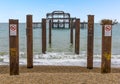 The pillars of the old West Pier looking toward the rusty remains off Brighton beach, UK Royalty Free Stock Photo