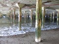 Pillars between sea and pier Royalty Free Stock Photo