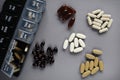 Pillbox by day next to different dietary supplements and tablets Royalty Free Stock Photo