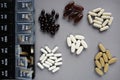 Pillbox by day next to different dietary supplements and tablets Royalty Free Stock Photo