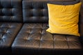 Pillow on black leather couch. Royalty Free Stock Photo