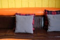 pillow on brown orange leather sofa couch beside yellow wall Royalty Free Stock Photo