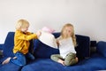 Pillow fight. Brother and sister play together. Active games for siblings at home