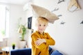 Pillow fight. Mischievous preschooler child jumping on a sofa and hitting with pillows.Active games for child at home
