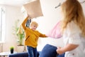 Pillow fight. Brother and sister play together. Active games for siblings at home