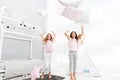 Pillow fight pajama party. Evening time for fun. Sleepover party ideas. Girls happy best friends or siblings in cute