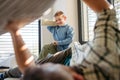 Pillow fight between young son and father. Dad spending time with son at home, having fun. Royalty Free Stock Photo