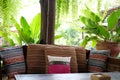 pillow on wooden settee bench on terrace patio near garden Royalty Free Stock Photo