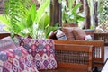 pillow on wooden settee bench on terrace patio near garden