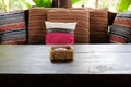pillow on wooden settee bench on terrace patio near garden Royalty Free Stock Photo
