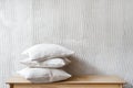 Pillows in cotton pillowcases on wooden bench in bedroom