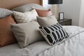 Pillows setting on bed with brown leather headboard Royalty Free Stock Photo