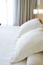 Pillows with white covers on luxury hotel king size bed