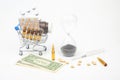 Pills, ampoules and syringe for injection, money dollars and hourglass on a white background. business and medicine