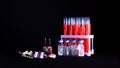 Pills on a background of test tubes with red liquid and ampoules on a black background