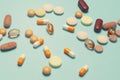 Pills on a blue background. Assorted pharmaceutical medicine pills, tablets and capsules, health macro. Heap of various pills Royalty Free Stock Photo