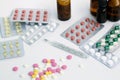 Pills and tablets with thermometr on white background Royalty Free Stock Photo