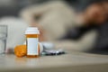 Pills bottles and glass of water on wooden table. Medicine, pharmacology, healthcare concept Royalty Free Stock Photo