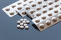 Pills in bubble-packed Aluminum Foils on Glass Background