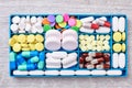 Pills and capsules in container.