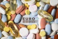 Pills and capsules on euro banknotes as a concept of increasing health care costs Royalty Free Stock Photo