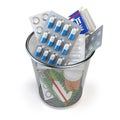 Pills, capsules and medicines thrown in the dustbin isolated on Royalty Free Stock Photo