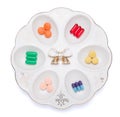 Pills, capsules and tablets on white plate