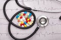 Stethoscope and colorful pills on